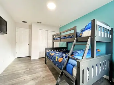 a bedroom with two bunk beds with blue walls at Mariel Oasis home in Kissimmee