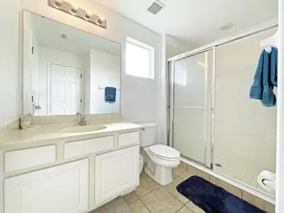 a bathroom with a sink and a toilet and a shower at Mariel Oasis home in Kissimmee