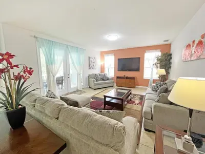 a living room with a couch and a tv at Mariel Oasis home in Kissimmee