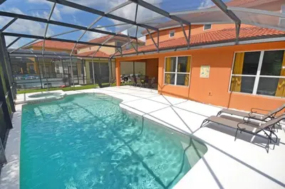 a swimming pool in the backyard of a house at Summer Sparkle home in Kissimmee