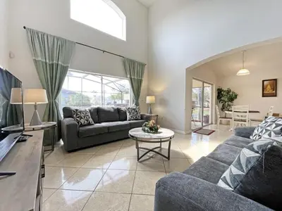 a living room with two couches and a table at Ainsdale Haven home in Kissimmee