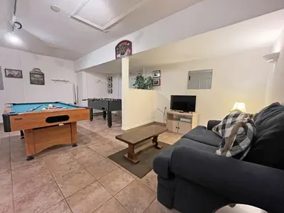 a living room with a pool table and a couch at Ainsdale Haven home in Kissimmee