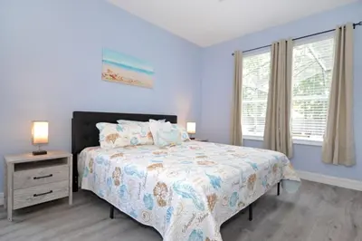 a bedroom with a bed and a window at Hideaway Dream home in Kissimmee