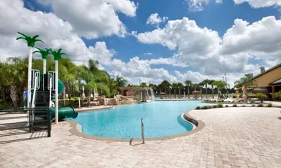 a pool at a resort with a slide at Bamboo Palm home in Kissimmee