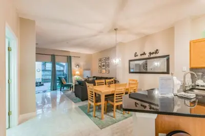 a kitchen and dining room with a table and chairs at Pompano Place townhouse in Kissimmee
