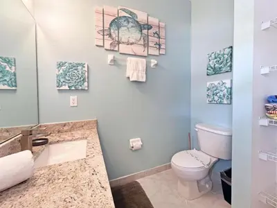 a bathroom with a toilet and a sink at Pompano Place townhouse in Kissimmee