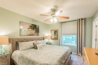 a bedroom with a bed and a ceiling fan at Pompano Place townhouse in Kissimmee