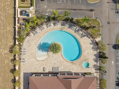 an overhead view of a swimming pool at a resort at Beautiful & Cozy 4bd Home, Gated Community in Kissimmee