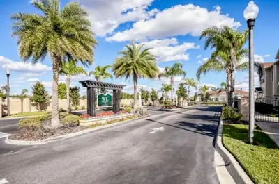 a street with palm trees and a street light at Beautiful & Cozy 4bd Home, Gated Community in Kissimmee