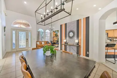 a dining room and living room with a table and chairs at Clermont Vacation Rental with Pool 11 Mi to Disney in Orlando