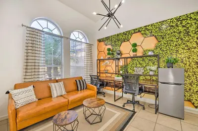 a living room with a couch and a table at Clermont Vacation Rental with Pool 11 Mi to Disney in Orlando