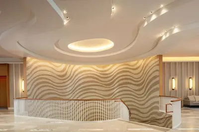 a lobby with a ceiling with a patterned wall at Conrad Orlando in Orlando