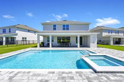 a house with a swimming pool in front of a house at Alluring Home Near Disney With Themed, Media And Game Room With Waterpark & Resort Access At Encore Resorts Reunion - 232Au in Kissimmee