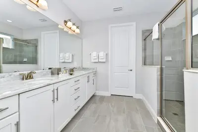 a white bathroom with two sinks and a shower at Modern Home With Private Pool Near Disney With Waterpark & Resort Access At Encore Resort - 7655Ff in Kissimmee
