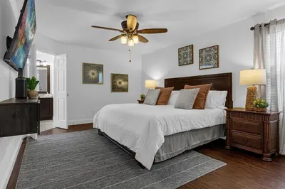 a bedroom with a bed and a ceiling fan at Hidden gem! Gorgeous villa next to Disney in Kissimmee