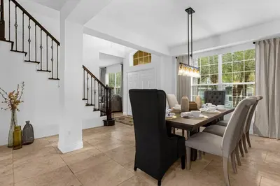 a dining room with a table and chairs at Hidden gem! Gorgeous villa next to Disney in Kissimmee