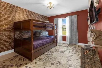 a bedroom with two bunk beds and a brick wall at Hidden gem! Gorgeous villa next to Disney in Kissimmee