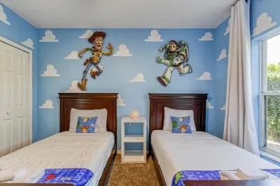 two twin beds in a room with blue walls at Large Home-Private Pool, Spa, and Pet Friendly Sleeps 12 in Orlando
