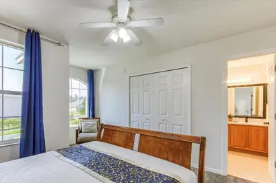 a bedroom with a bed and a ceiling fan at Large Home-Private Pool, Spa, and Pet Friendly Sleeps 12 in Orlando