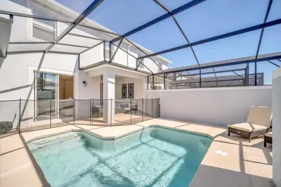 a swimming pool in a house with a glass ceiling at Amazing Story Lake Town Home With Pool townhouse in Kissimmee
