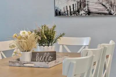 a dining room table with white chairs and a wooden tray with plants at Windsor Hills Resort Poolside Ground Floor 3 Bed Condo in Orlando