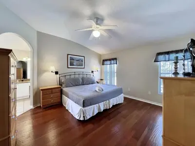 a bedroom with a bed and a ceiling fan at Lovely Lakeside 4-Bed Pool Home at Villa Sol-3125 home in Kissimmee