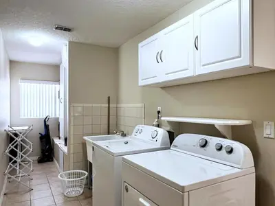 a laundry room with a washer and a sink at Lovely Lakeside 4-Bed Pool Home at Villa Sol-3125 home in Kissimmee