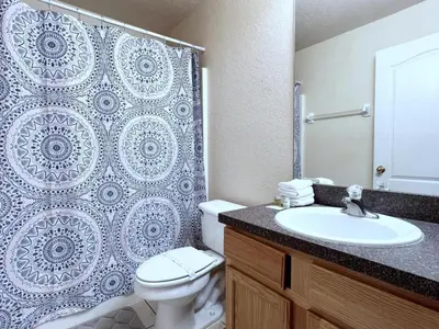 a bathroom with a toilet and a sink and a shower at Lovely 3-Bedroom Pool Villa-1445SCD villa in Orlando