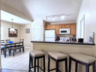 a kitchen and dining room with a table and chairs at Lovely 3-Bedroom Pool Villa-1445SCD villa in Orlando