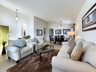 a living room with two couches and a table at Cozy 4 Bed 3 Bath Pool Hm with Game Room-4450NP home in Kissimmee