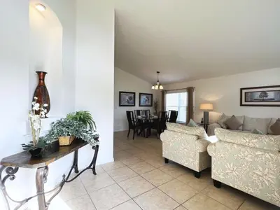 a living room with two couches and a table at Cozy 4 Bed 3 Bath Pool Hm with Game Room-4450NP home in Kissimmee