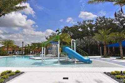a swimming pool with a slide in a resort at Cozy 4 Bed 3 Bath Pool Hm with Game Room-4450NP home in Kissimmee