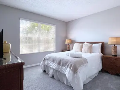a bedroom with a white bed and a window at Spacious 7Bd Pool Gm Hm Terra Verde Resort-211HBL home in Kissimmee