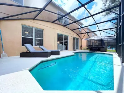 a swimming pool with a pergola next to a house at Spacious 7Bd Pool Gm Hm Terra Verde Resort-211HBL home in Kissimmee