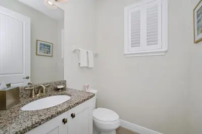 a white bathroom with a sink and a toilet at Inviting Home Near Disney With Private Pool And Waterpark & Resort Access At Encore Resorts Reunion - 7578Mr in Kissimmee