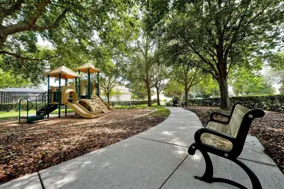 a park with two benches and a playground at Mickey's Welcome Inn - Closest Resort to Disney in Orlando