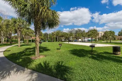 a park with palm trees and a volley ball court at Mickey's Welcome Inn - Closest Resort to Disney in Orlando