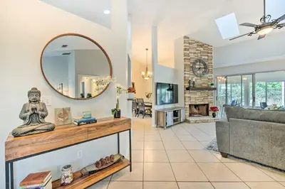 a living room with a mirror and a couch at Walk to Lake Stunning Central Florida Home! in Lake Mary