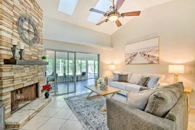 a living room with a couch and a fireplace at Walk to Lake Stunning Central Florida Home! in Lake Mary
