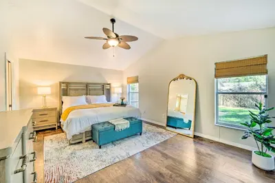 a bedroom with a bed and a large mirror at Walk to Lake Stunning Central Florida Home! in Lake Mary