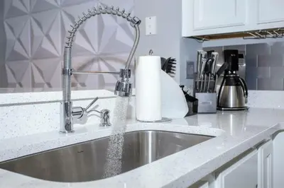 a kitchen sink with a faucet on a counter at Amazing 3 Bdrms At Encantada- 6 miles from Disney in Kissimmee