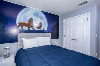 a bedroom with a blue bed and a painting of a horse at Amazing 3 Bdrms At Encantada- 6 miles from Disney in Kissimmee