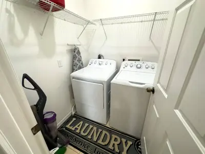a laundry room with a washer and dryer at Comfortable Apart 4Bdrm3Bath- 4 miles to Disney in Orlando