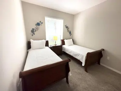 a bedroom with two beds and a window at Comfortable Apart 4Bdrm3Bath- 4 miles to Disney in Orlando