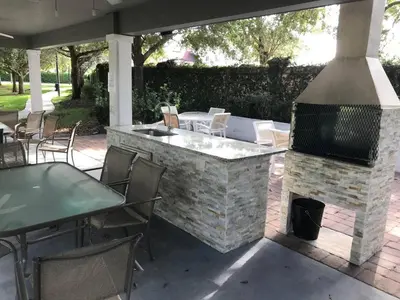 a patio with a fireplace and a table and chairs at Amazing 3 bedrooms At Lucaya- 7 miles from Disney in Kissimmee