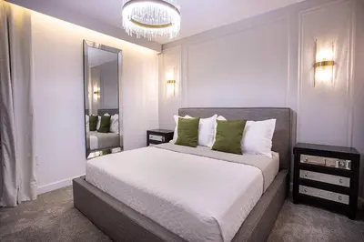 a bedroom with a large bed and a mirror at New Home 8 Bedrooms and 5 Bathrooms At Storey Lake in Kissimmee