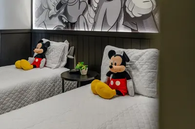 two stuffed animals sitting on two beds in a room at Amazing 3Bdrms At Encantada -6 miles from Disney in Kissimmee