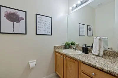 a bathroom with a sink and a mirror at Amazing 3Bdrms At Encantada -6 miles from Disney in Kissimmee