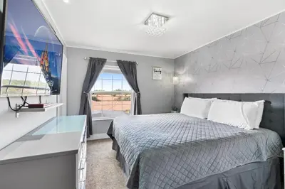 a bedroom with a bed and a desk and a window at Cozy 3Bdrms At Encantada- 6 miles from Disney in Kissimmee