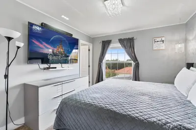 a bedroom with a bed and a flat screen tv at Cozy 3Bdrms At Encantada- 6 miles from Disney in Kissimmee